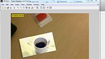 Use object recognition and tracking to create an augmented reality application with a webcam in MATLAB . Recognize an image in a scene, track its position, and augment the display by playing a video in the image’s place.